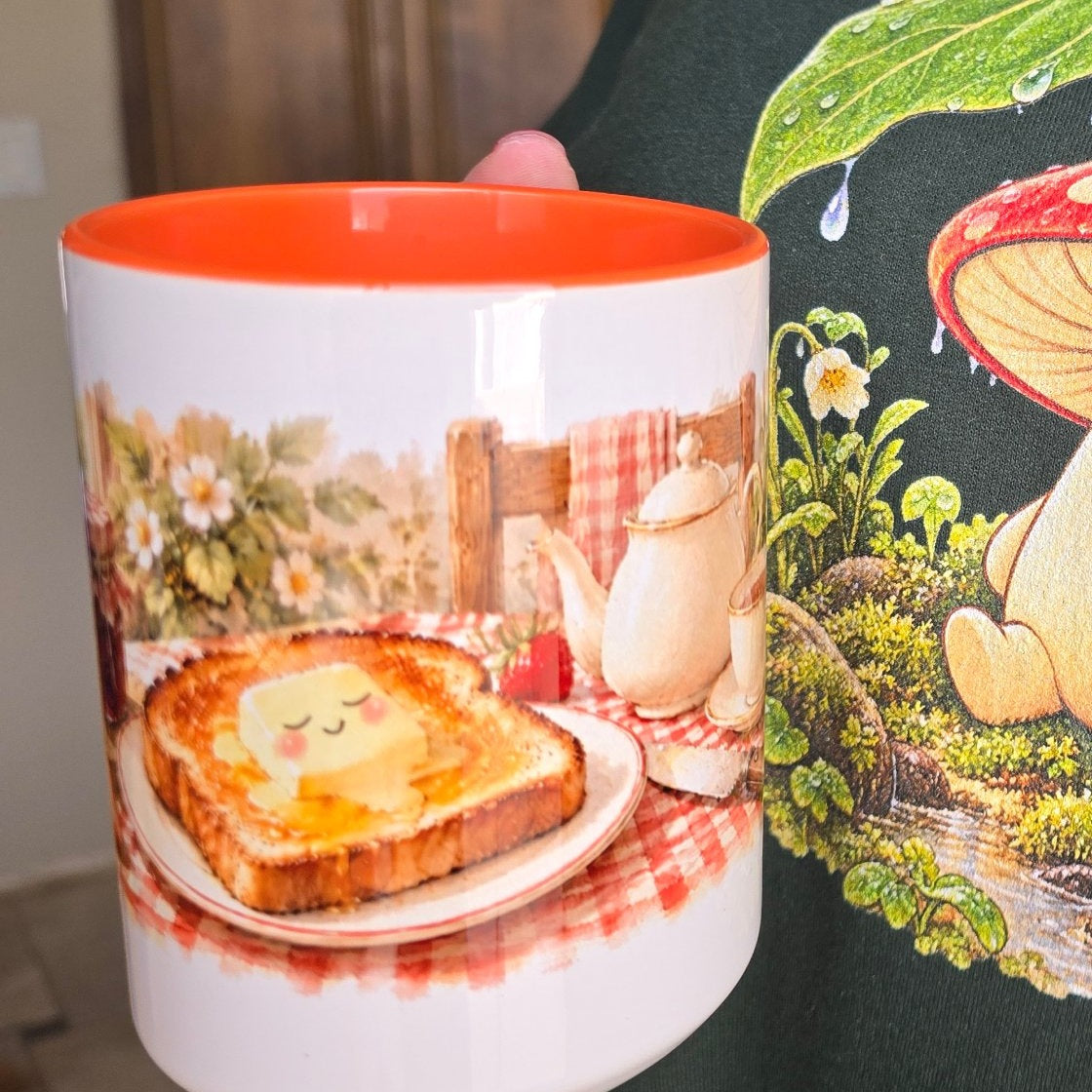 Real photo of the Buttered Toast mug with an orange inside, held in hand