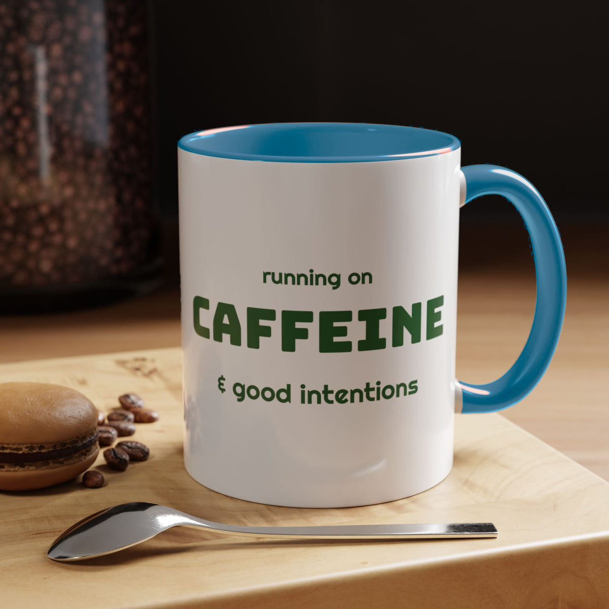 Caffeine and Good Intentions mug, green lettering, light blue handle, 11oz