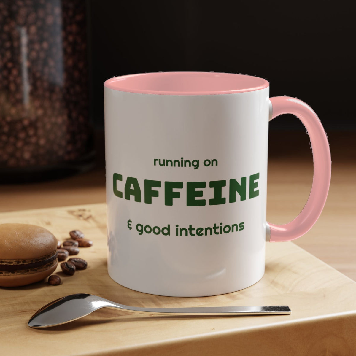 Caffeine and Good Intentions mug, green lettering, pink handle, 11oz